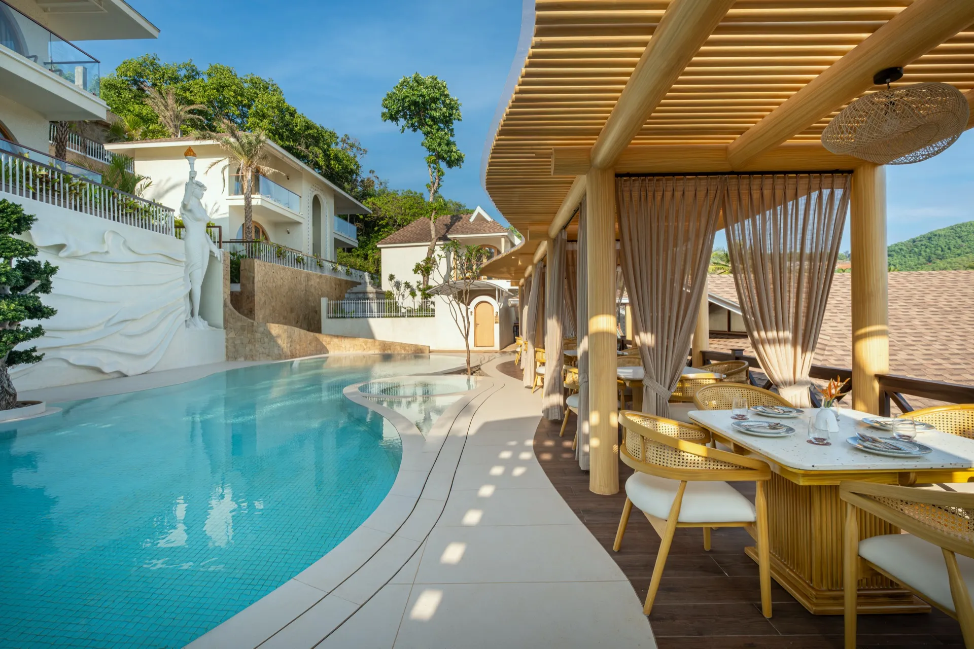 Aloha Resort pool area with cabana dining and resort building