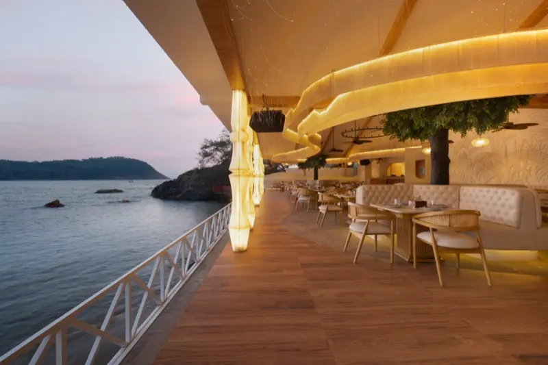 Aloha Resort from Kudle Beach with ocean waves and hillside sign