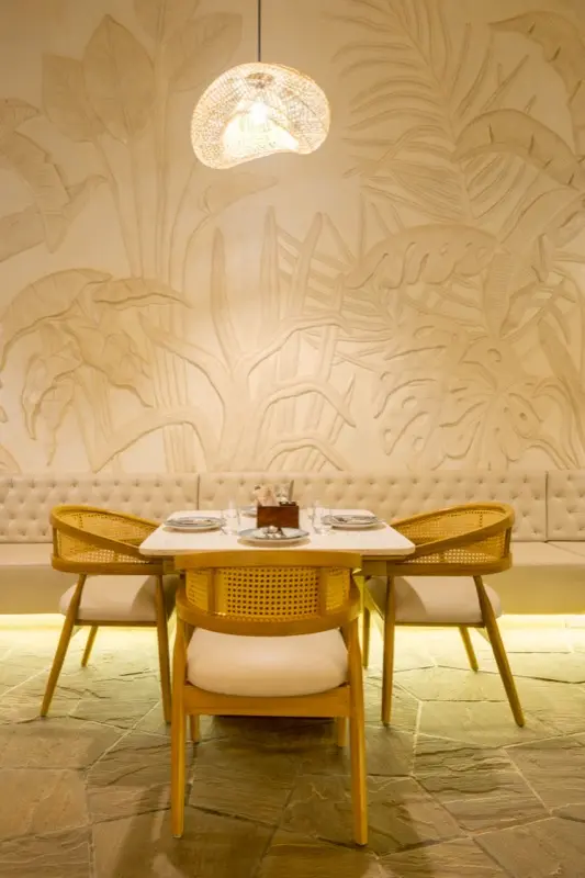 Cozy dining nook with botanical wall art and warm lighting