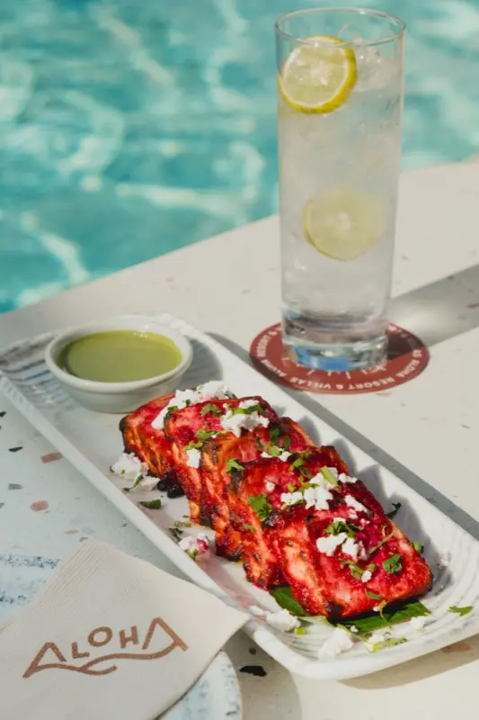 Grilled tandoori dish with chutney served poolside