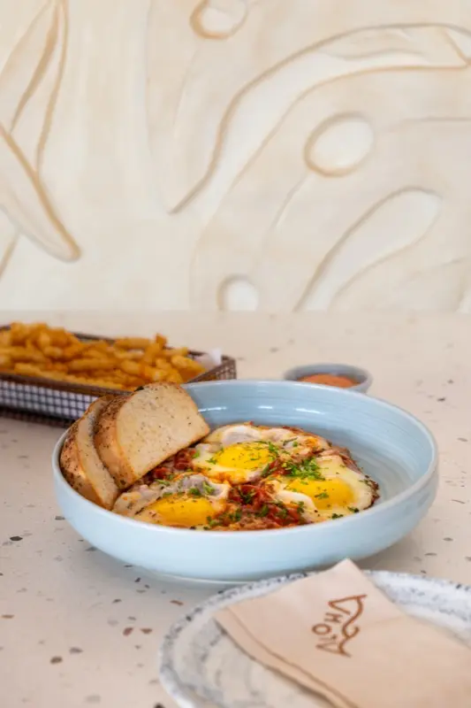 Shakshuka eggs with toast and herbs at Cafe Aloha