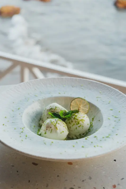 Lime sorbet dessert with ocean backdrop