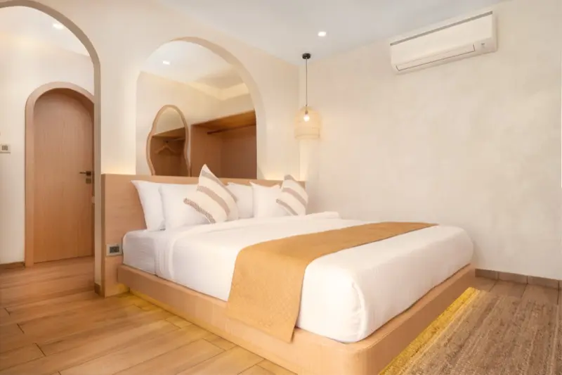 Room 101 king bedroom with arched doorways and pendant light