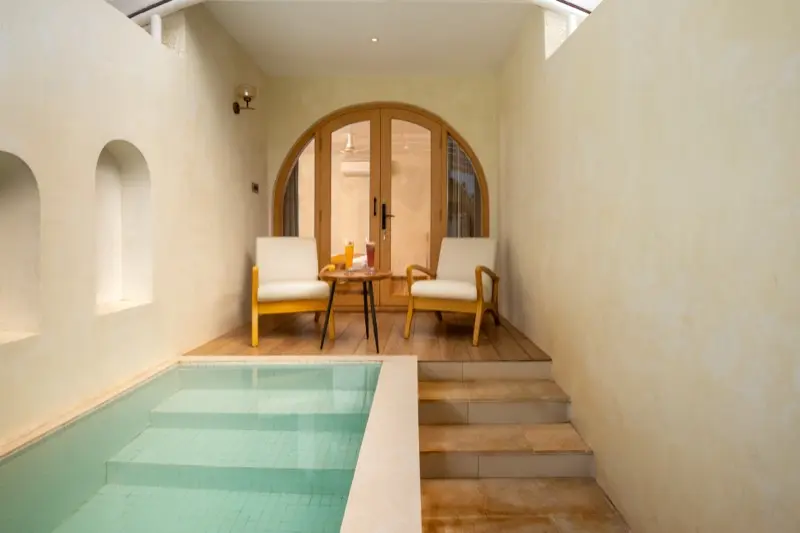 Private plunge pool with seating area and arched doorway