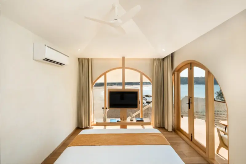 Room 102 bedroom with arched niches and wooden headboard