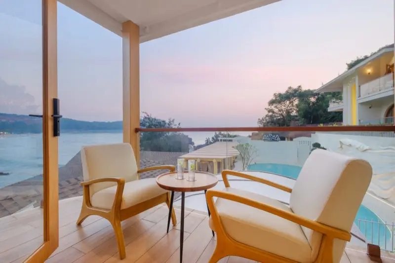 Balcony with pool and sea view at sunset