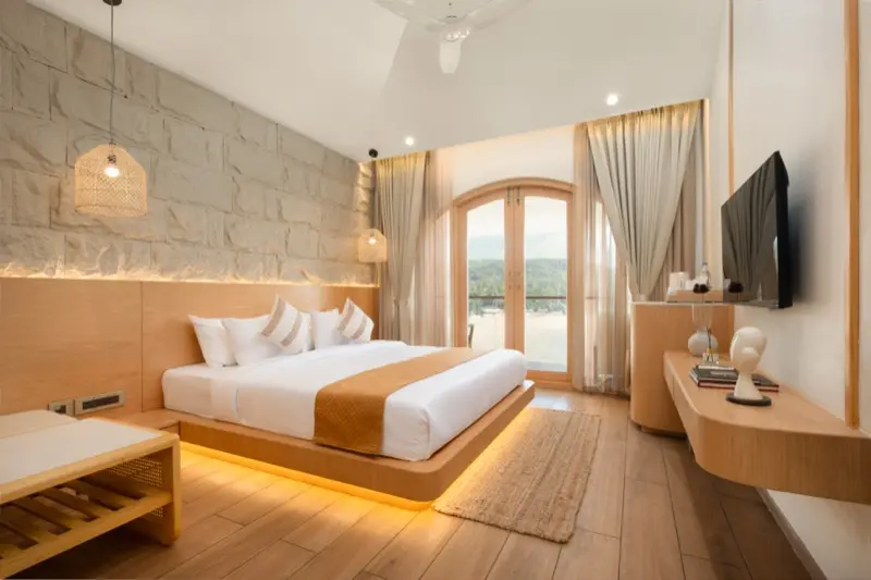 Room 203 wide view with stone wall and warm wood furnishings