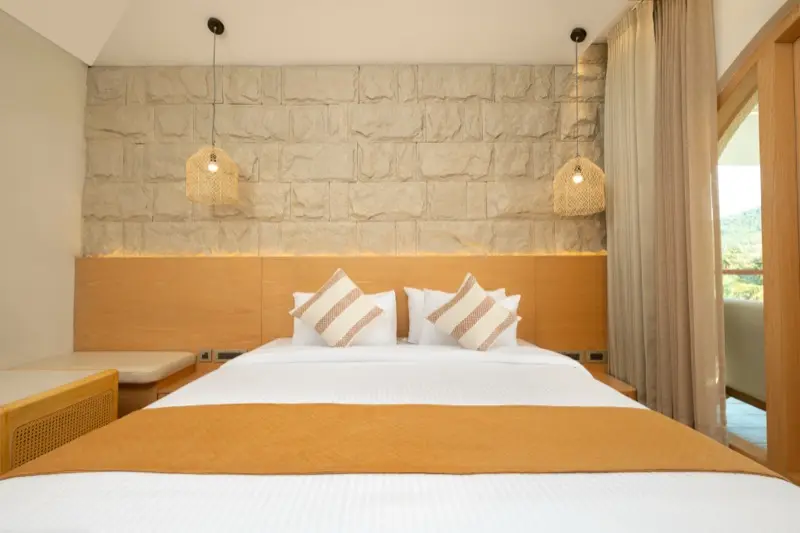 Room 203 frontal with stone wall and wicker pendant lights